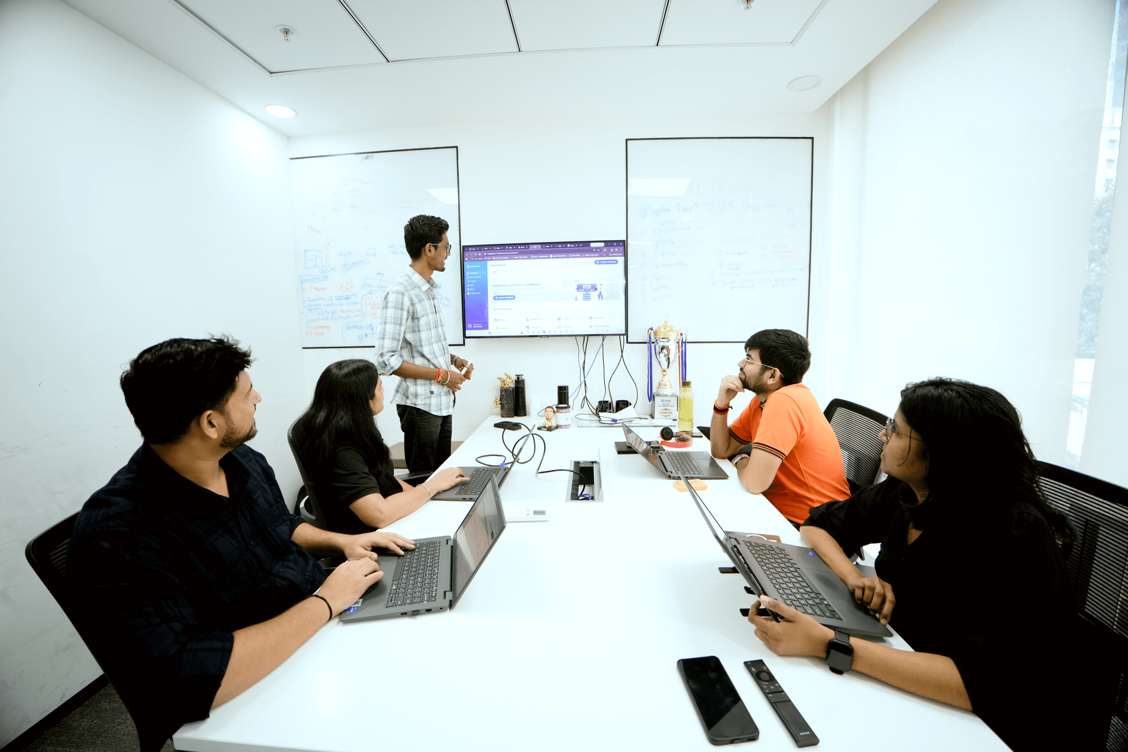 Yukosa team members participating in a late-night hackathon with a glowing team display